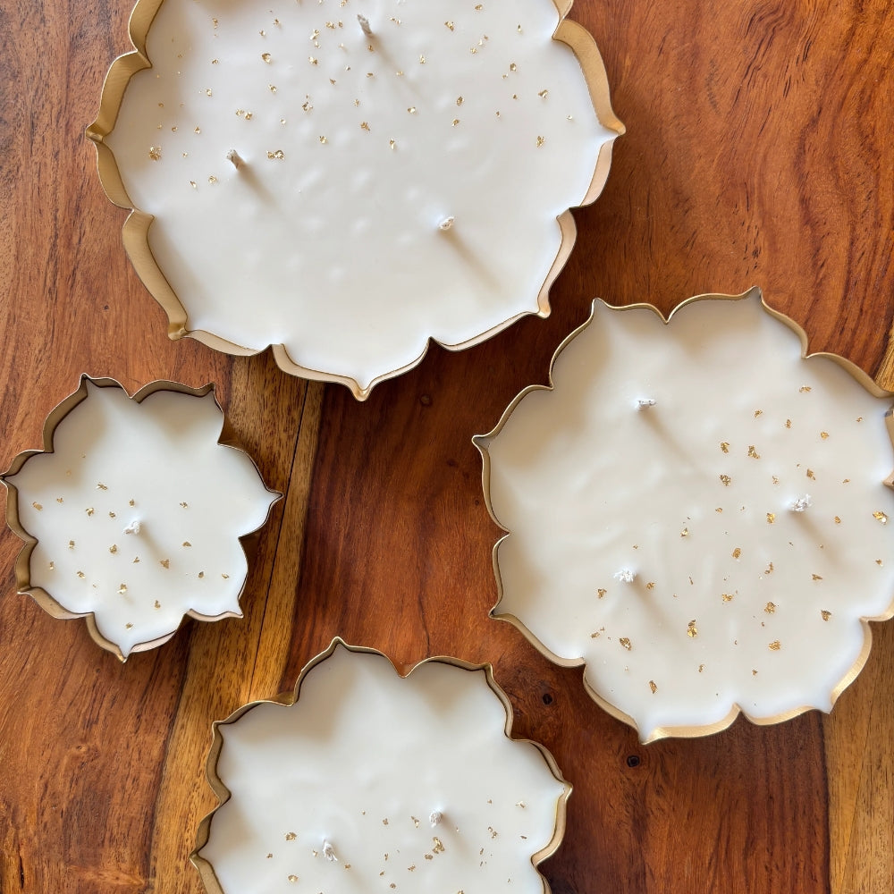 Glittering beeswax urli candles with gold flakes for Diwali home decoration