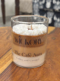 Handcrafted Wickory beeswax candle in a clear glass jar with layered coffee-brown and ivory wax, topped with textured white wax, labeled “The Café Aura – Coffee and Caramel.”