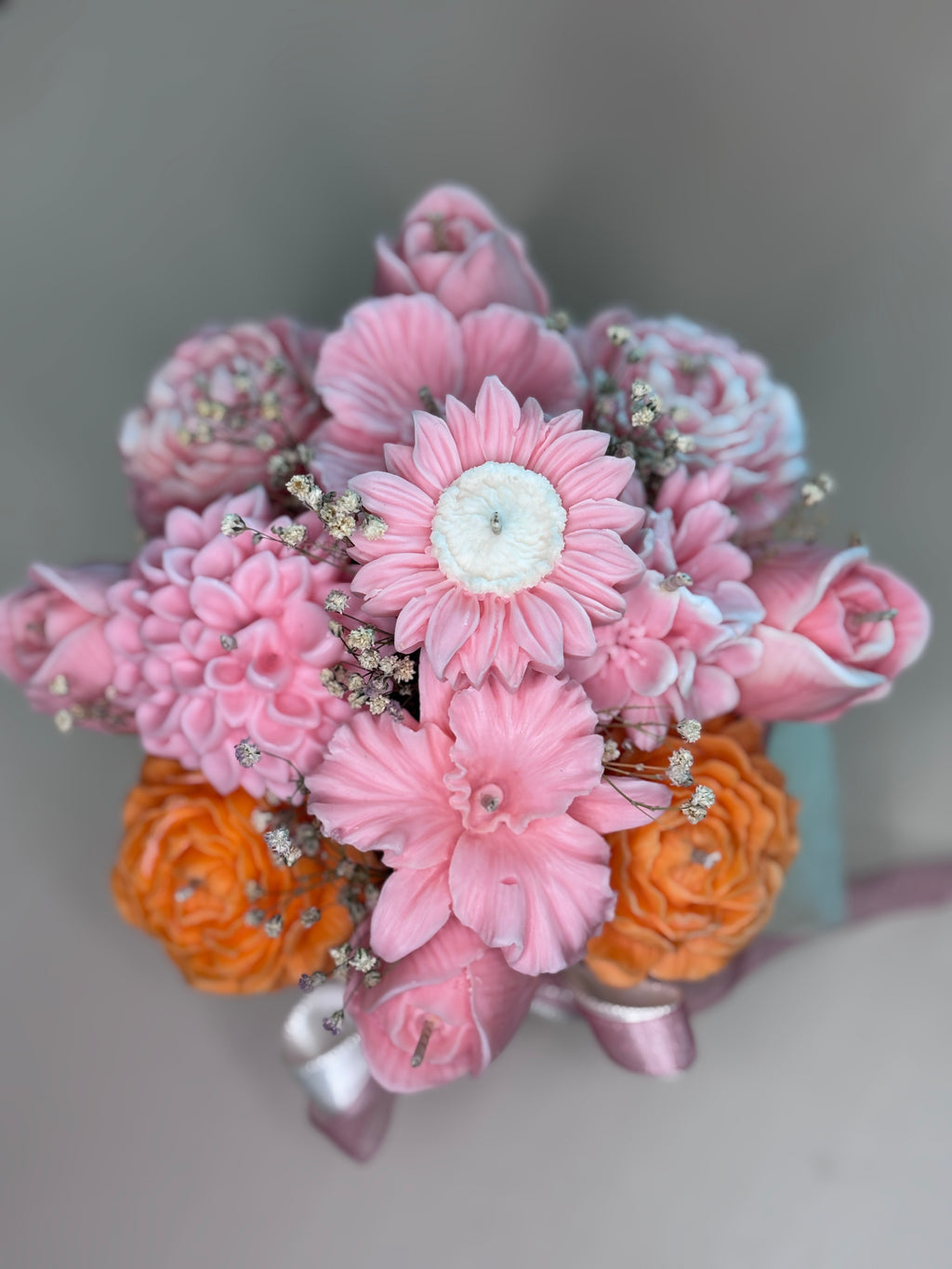 Close-up of Wickory Blossom Garden beeswax flower candles showing richly detailed hand-poured petals and braided wicks in a layered garden-style arrangement