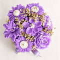 Wickory Blossom Bunch: lavender and purple sculpted beeswax flower candles with daisy-style blooms and roses, tied with a lavender ribbon