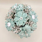 Wickory Blossom Bunch: mint green and white sculpted beeswax flowers with white filler flowers, seen from above