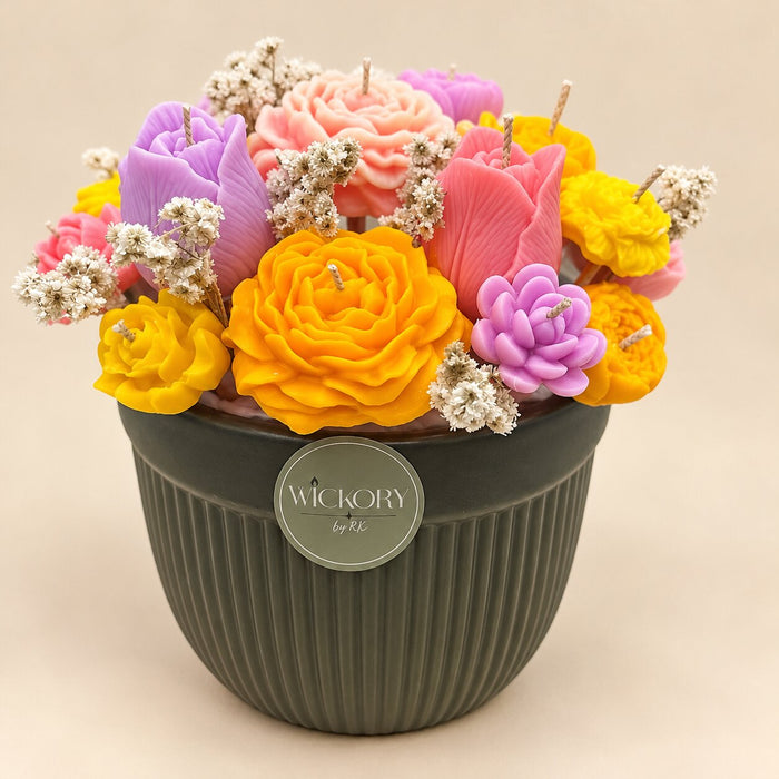 The Blossom Garden: orange, yellow, pink and purple sculpted beeswax flowers in a ribbed grey-green pot with a Wickory label