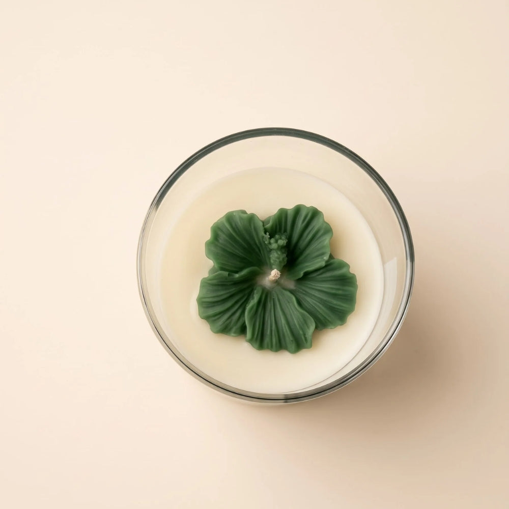 The Blush Petal in green, top view: a sculpted green flower on ivory wax
