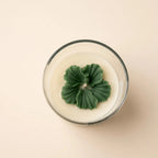 The Blush Petal in green, top view: a sculpted green flower on ivory wax