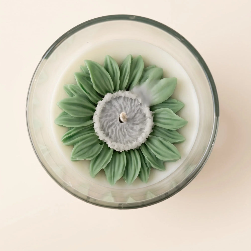 The Blush Petal in green from above: a sculpted green daisy-style flower with a grey centre