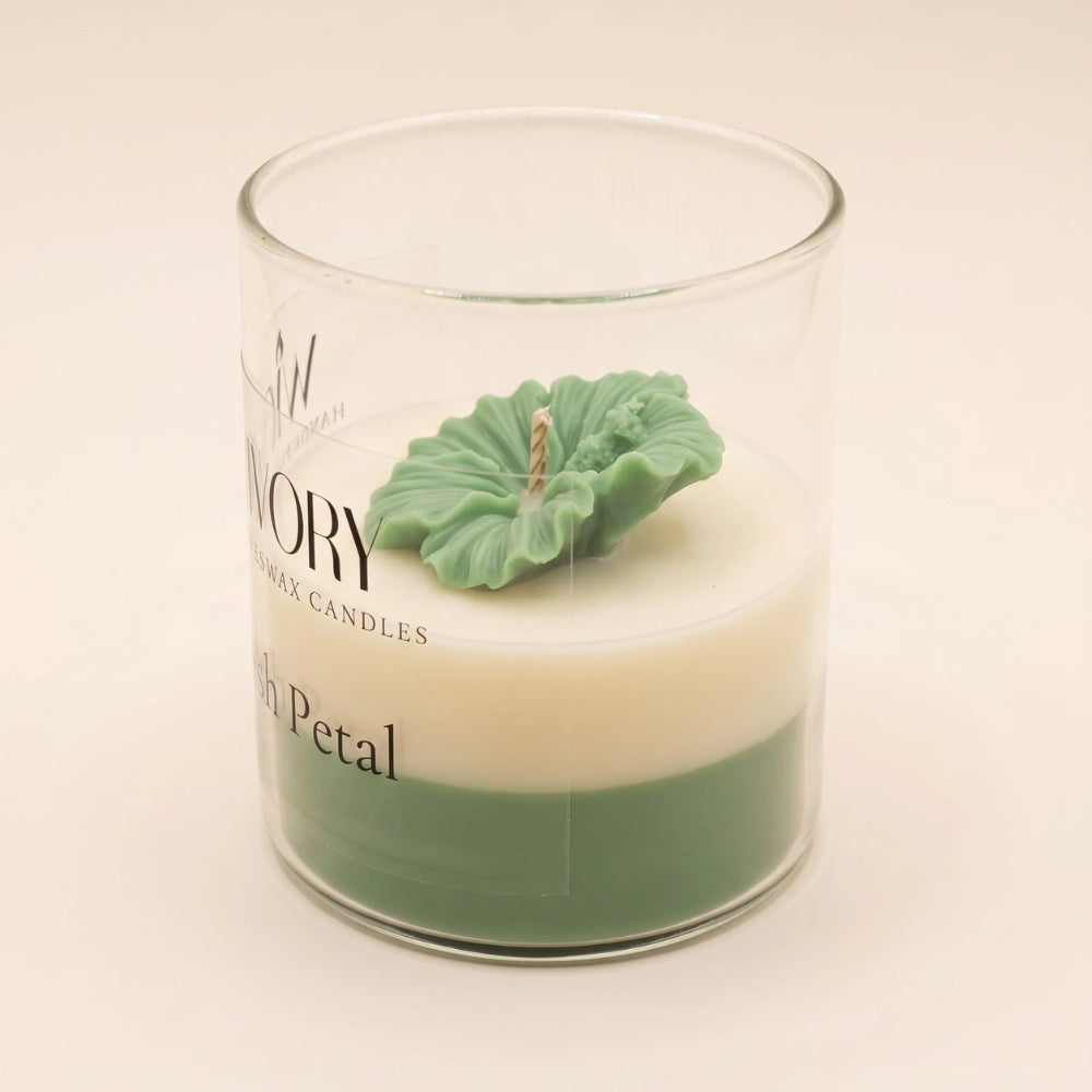The Blush Petal in green: a sculpted green flower on ivory and green layered wax in a labelled glass jar