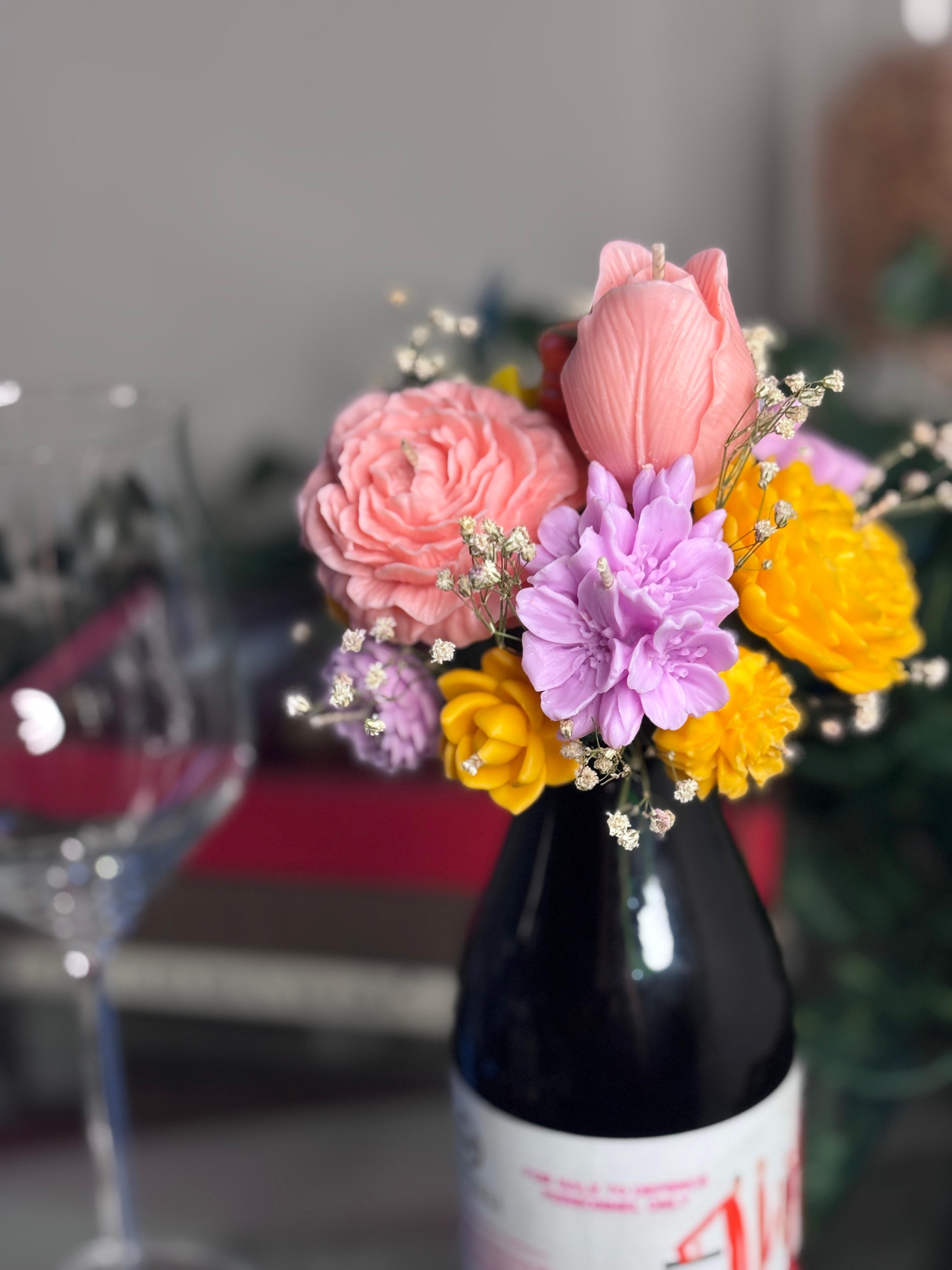 Wickory Cork and Bloom handcrafted beeswax floral candle topper placed over a wine bottle, featuring hand-poured florals in yellow — a unique luxury gift for wine lovers