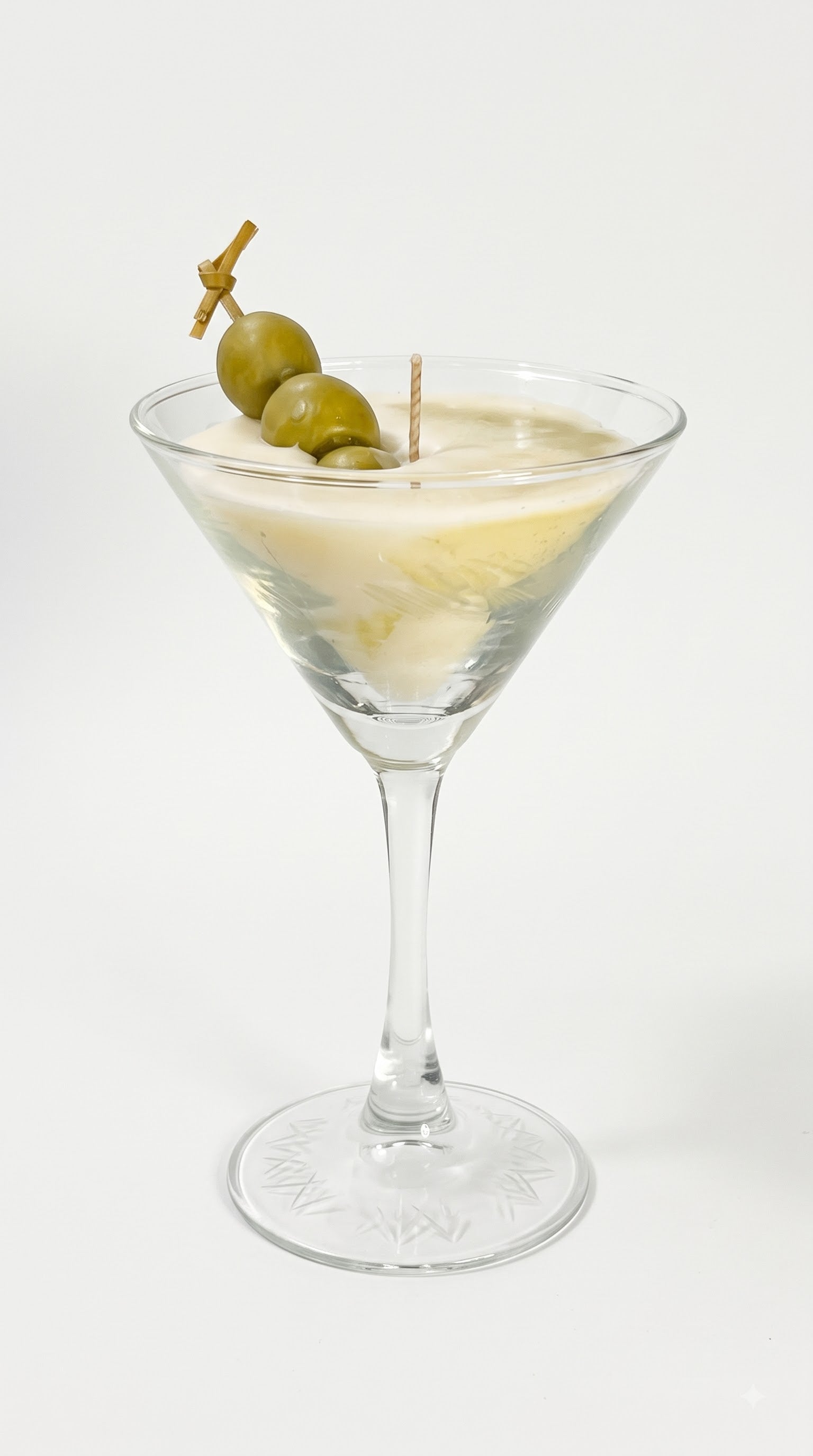 Wickory Dirty Martini beeswax candle in a classic martini glass silhouette, smooth ivory wax finished with hand-detailed olives