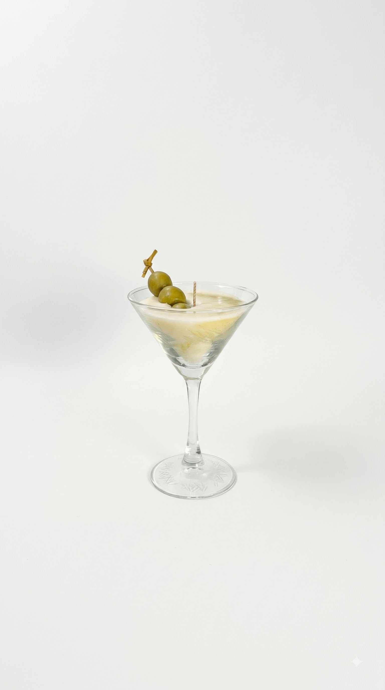 Wickory Dirty Martini beeswax candle in a classic martini glass silhouette, smooth ivory wax finished with hand-detailed olives