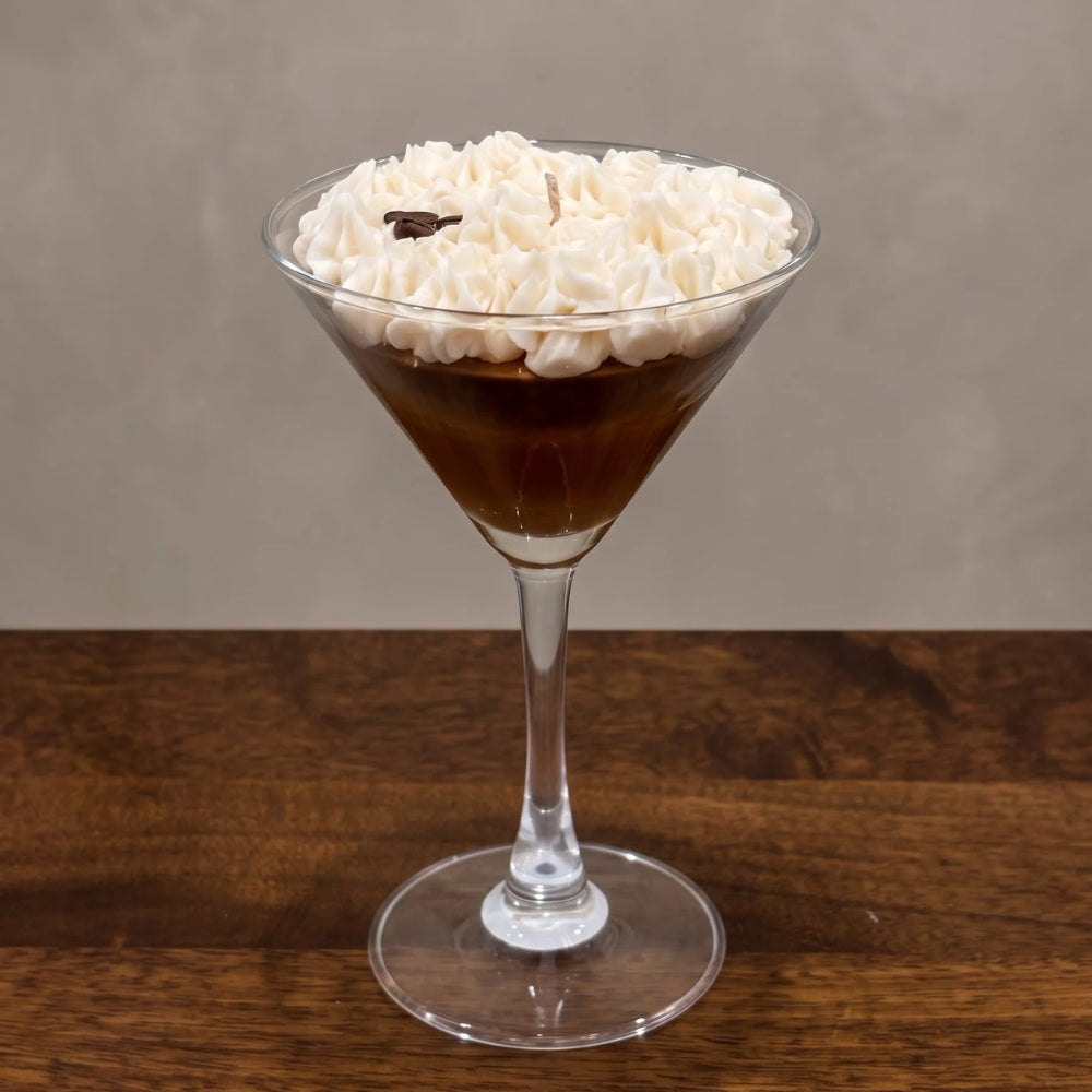Espresso Martini beeswax candle with a whipped top and a coffee bean in a martini glass, on a wooden table