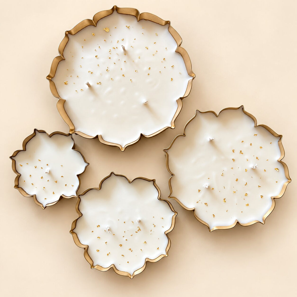 Glittering Urlis decorative candles in gold-edged floral-shaped bowls with gold flakes
