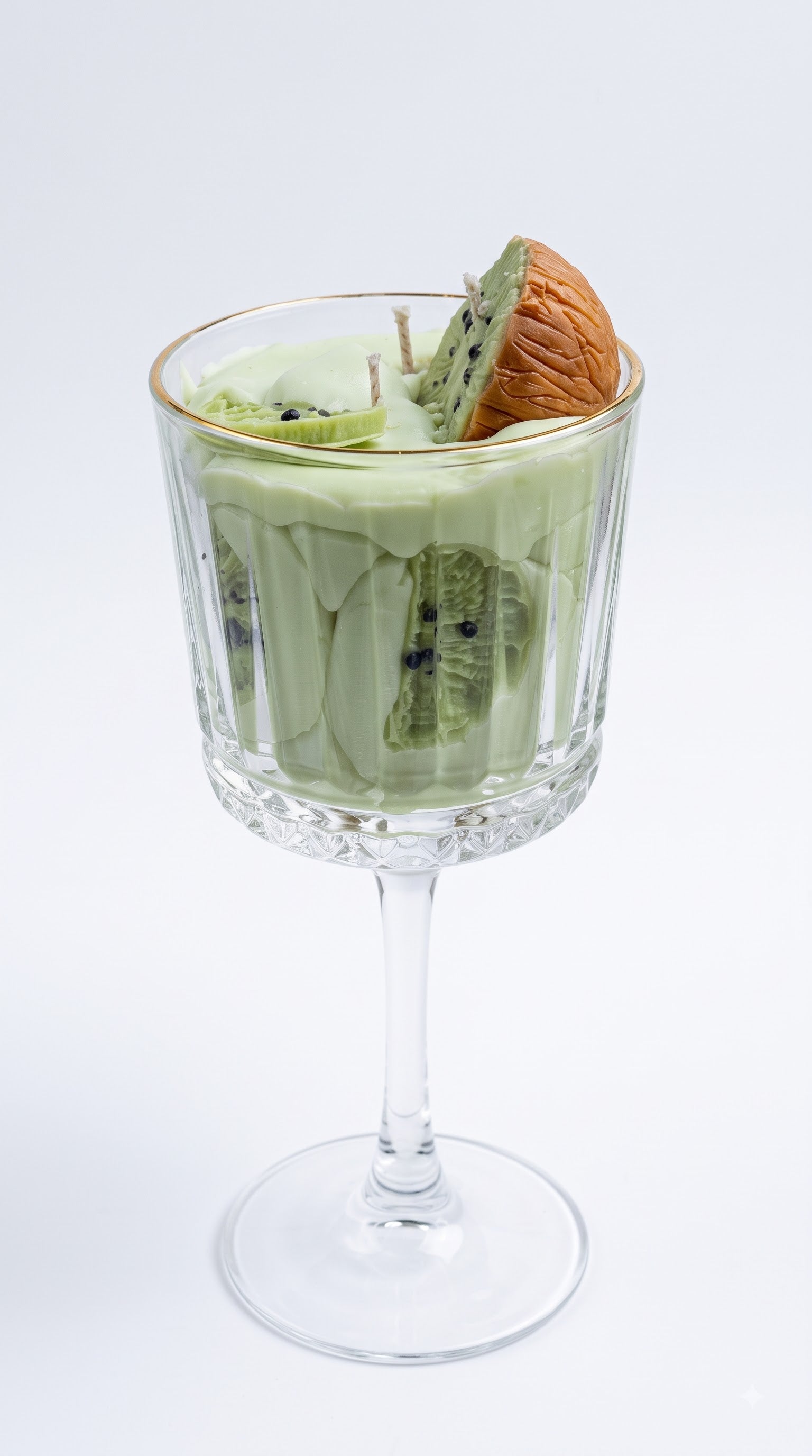 Wickory Kiwi Colada beeswax candle, soft green wax in a stemmed glass finished with hand-pressed kiwi slices and coconut detail