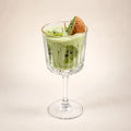 Kiwi Colada beeswax candle: pale green wax with a kiwi garnish in a stemmed glass