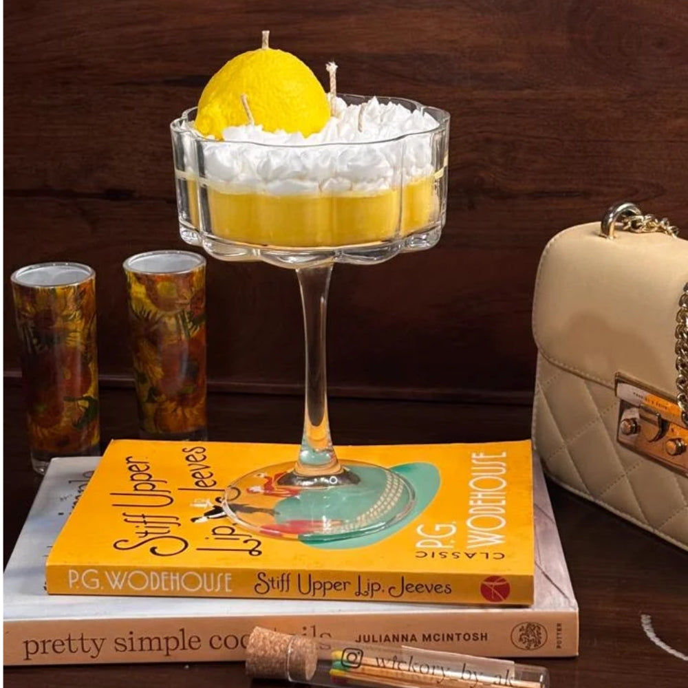 Limoncello candle styled on a stack of books
