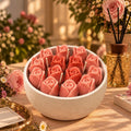 The Secret Garden: sculpted pink rose candles in a white ceramic bowl