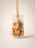 Shubh Arambh beeswax wax sachet with a sculpted Ganesha and a gold ribbon
